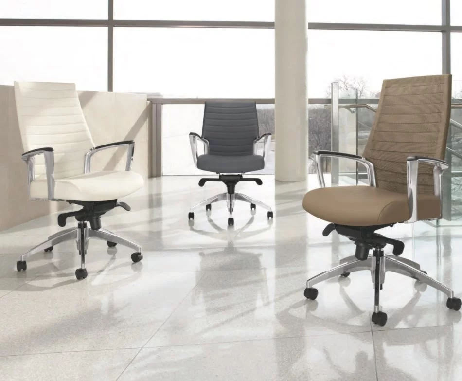 Global Accord Chairs - Three Global Accord chairs in a sunny office with high windows. A white upholstered high back and meshback Accord chair faces eachother. Further back is a black mid-back model of Accord chair.