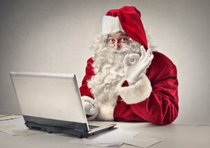 Santa Clause giving the okay sign on his laptop