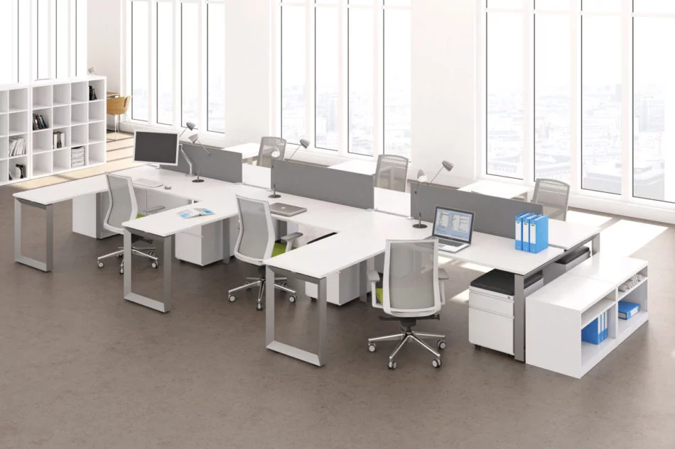 Studio photography of AMQ's Icon Benching. There is two 6-Pack single run workspaces, each with a green cushioned chair placed at the desk. It is using the white laminate. Another part of the desk juts out. The sun is shining in from the window beyond.