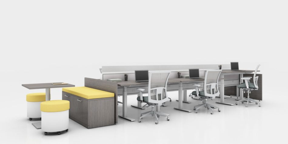 Global's 6-person power beam desks on a white studio set. Each workstation has a laptop open, with glass paneling for privacy. At one end is a cabinet with sunflower yellow cushions, and a square Swap table.