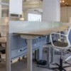 Global's 6-person power beam desks in a large office space. Three workstations are set up with the Foil tables adjusted higher than the three workstations facing it.