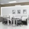 Two sets of Global's 4-person power beam desks.Each workstation has a laptop open. To the user's right are credenzas with Acoujou paneling