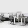 Global's 8-person power beam desks in a white studio setting. Each workstation has a laptop open. To the user's right are credenzas with Acoujou paneling