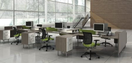 Studio photography of Global's 6-person sidebar benching with a grey wood finish. Full length windows bring sunlight into the space, with a stairway just behind.
