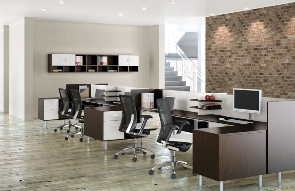 Studio photography of Global's 6-person sidebar benching has a dark walnut finish. A wall with a brick facade is just behind it, and an open ingress leads to a space with stairs leading up.