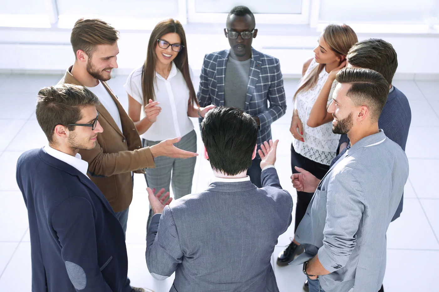 group of business associates standing in an ergonomic meeting