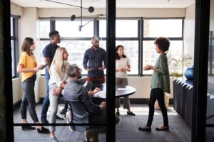 business meeting standing up but also one is seated in ergonomic chair