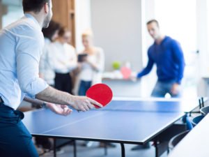 men playing ping pong at an active office