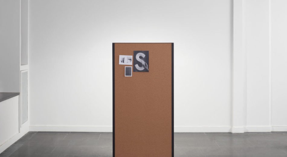 Studio shot of a single dB privacy panel. A set of notes and cards are pinned at the top.