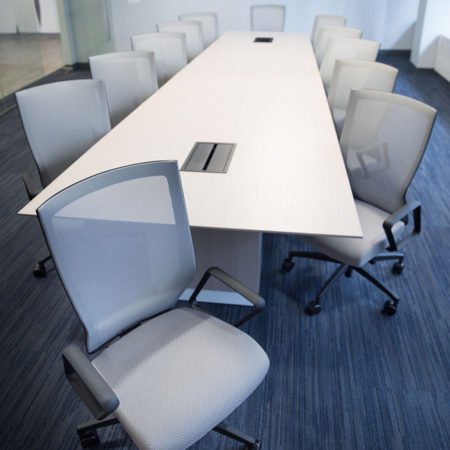 Twelve Run II chairs placed at a long conference table. Each chair has a grey mesh back with matching cushion.
