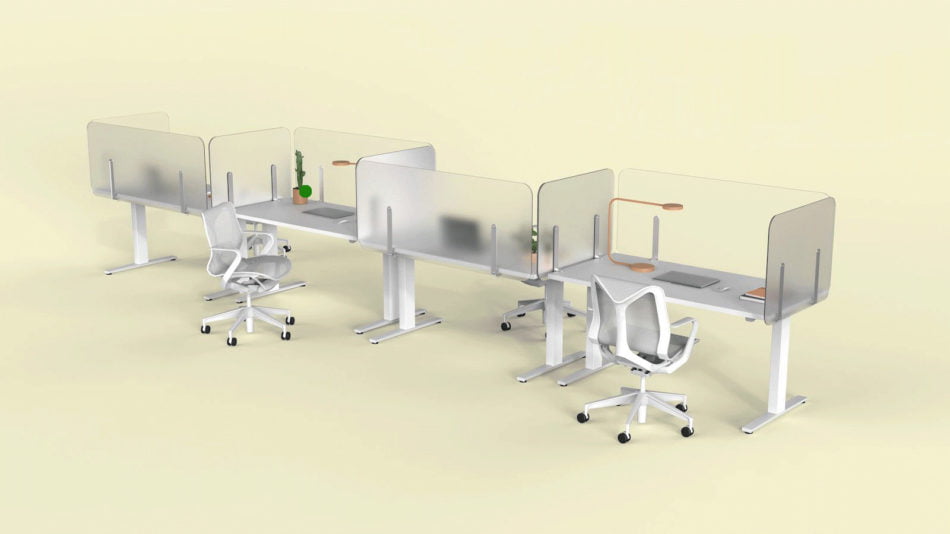 Four single tables placed together, with Shelter partition screens lining each. Each of the four work areas has a desk lamp, laptop, and a few folders to look at.