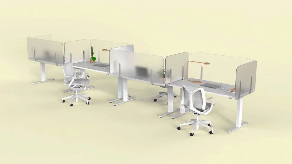 Four single tables placed together, with Shelter partition screens lining each. Each of the four work areas has a desk lamp, laptop, and a few folders to look at.