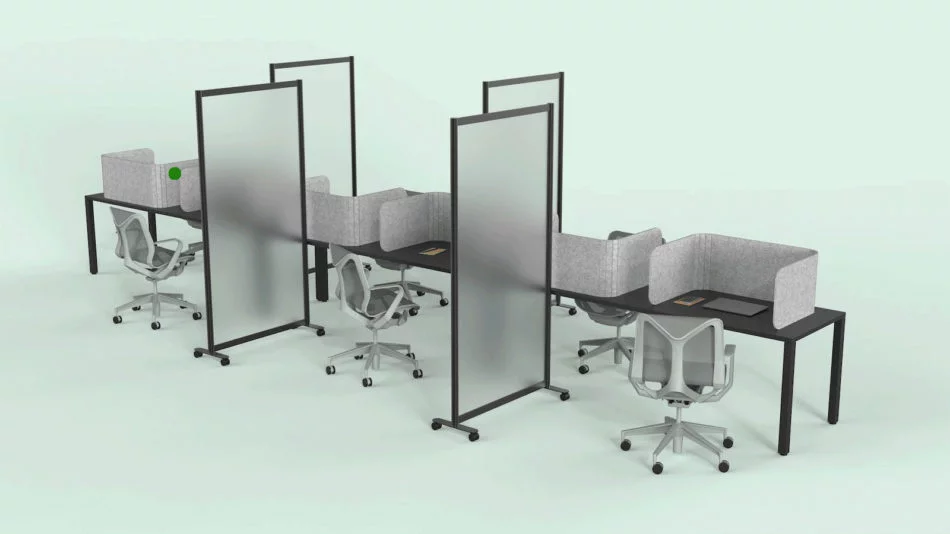 A long wooden table, set up for an office. Each work area is divided with a Hide privacy screen, with the laptop closed in front of it. Each middle seat (of each side of the table) has the Split semi-clear full length privacy screen.