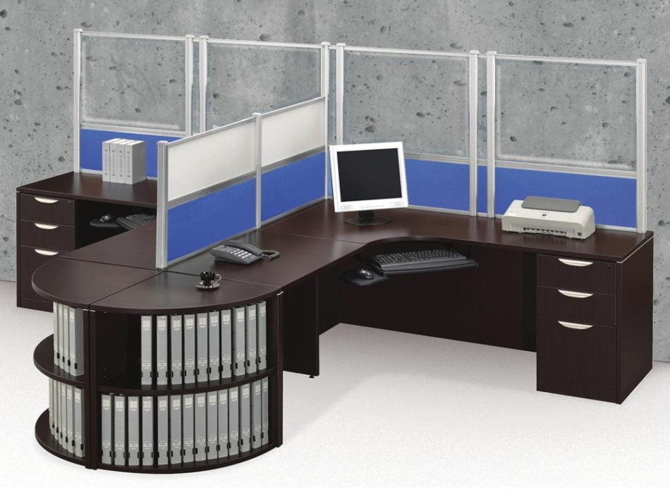 Tall Border (model) screens line the back of two L-shaped desks. Each screen uses clear acrylic, with a blue fabric panel at the bottom. Two shorter screens divide the desks on the side, with the top panels using frosted acrylic. Each desk has a computer monitor, with a phone at the side.