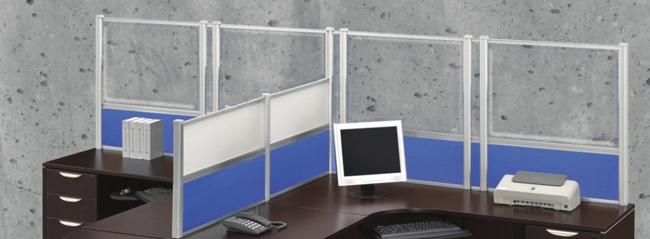 Wide shot of tall Border (model) screens lining the back and sides of two L-shaped desks. Each screen uses clear acrylic, and has a small spacer in between. Two shorter screens divide the desks on the side, with the top panels using frosted acrylic. Each desk has a computer monitor, with a phone at the side.