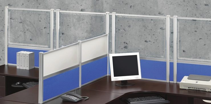 Wide shot of tall Border (model) screens lining the back and sides of two L-shaped desks. Each screen uses clear acrylic, and has a small spacer in between. Two shorter screens divide the desks on the side, with the top panels using frosted acrylic. Each desk has a computer monitor, with a phone at the side.