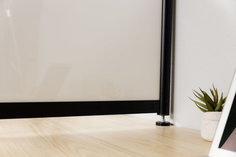 Close-up where the Hitch screen meets the back wall of a workstation.
