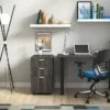 Studio shot of OTG's Home Office Setup, which has a 24" x 48" work table placed in the corner by the window. At the left is a set of pedestal drawers. The third (top) drawer has a lock on it. Both the desk and pedestal drawers are finished in an _____. A simple mesh-back office chair is pulled up to the laptop, with a LED lamp next to it.