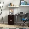 Studio shot of OTG's Home Office Setup, which has a 24" x 48" work table placed in the corner by the window. At the left is a set of pedestal drawers. The third (top) drawer has a lock on it. Both the desk and pedestal drawers are finished in an _____. A simple mesh-back office chair is pulled up to the laptop, with a LED lamp next to it.