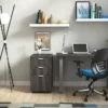 Studio shot of OTG's Home Office Setup, which has a 24" x 48" work table placed in the corner by the window. At the left is a set of pedestal drawers. The third (top) drawer has a lock on it. Both the desk and pedestal drawers are finished in an _____. A simple mesh-back office chair is pulled up to the laptop, with a LED lamp next to it.