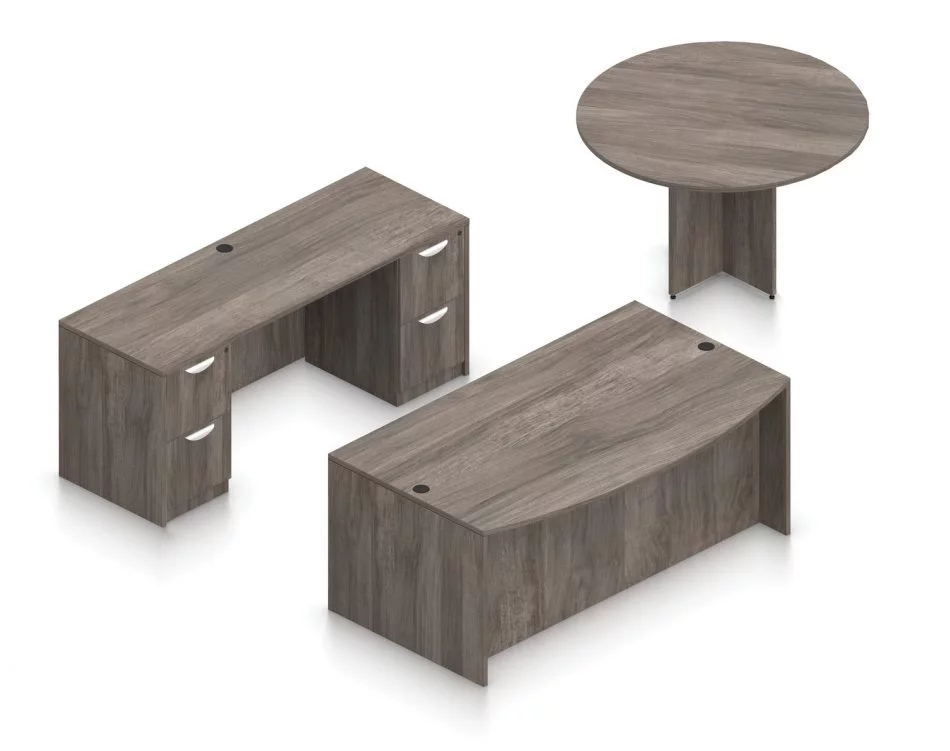 Orthographic view of an Offices to Go set of desks and tables, using Layout G. This set consists of a 71" bowed front style desk and a 48" round table to the side. A pair of file drawers are at each side, within a credenza at the back. This set is shown with the Artisan Grey laminate finish.