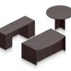 Orthographic view of an Offices to Go set of desks and tables, using Layout G. This set consists of a 71" bowed front style desk and a 48" round table to the side. A pair of file drawers are at each side, within a credenza at the back. This set is shown with the American Mahogany laminate finish.