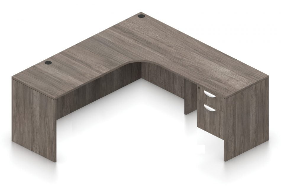 Orthographic view of an Offices to Go 71" corner desk with left side extension. Its inner edge is curved, and it has a set of two hanging office drawers to the right of it, with a lock on the top. This layout is featured in an Artisan Grey finish.