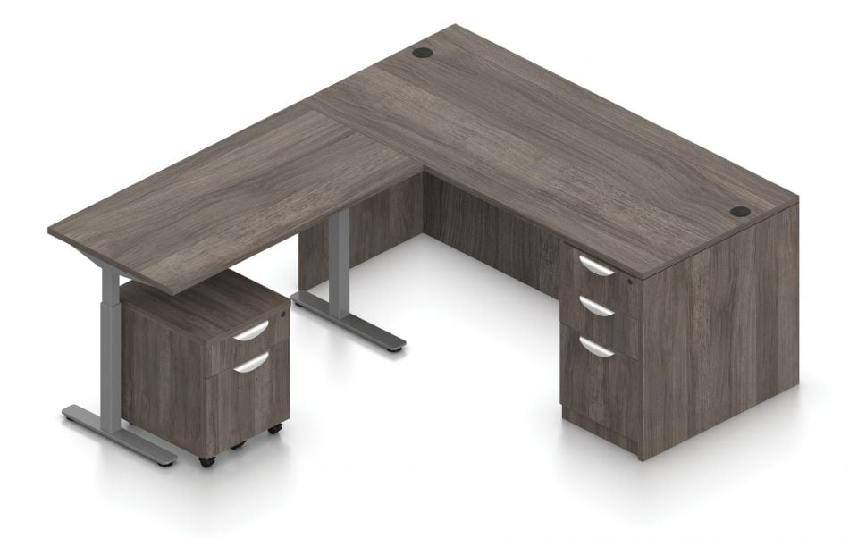 Orthographic view of an Offices to Go corner desk set, using Layout 7. A 66" wide desk and 48" table are arranged in an L-shape, the height adjustable table set level with the desk. A set of three file and drawers are set into the right side, with an additional set of pedestal drawers rolled underneath the table (at the other side). This layout is featured in an Artisan Grey finish.