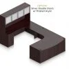Orthographic view of an Offices to Go set of desking, using Layout D. This set consists of a two 71" desks with corner extension/attachment. A matching width hutch is stacked on top, featuring two cabinets with optional upgrade of silver double doors. In the desk, at each side, is a set of pedestal drawers. The extension side features two equal height drawers, and the other side features a set of three drawers. Each one has a lock at the top. This desking uses an American Mahogany laminate finish.