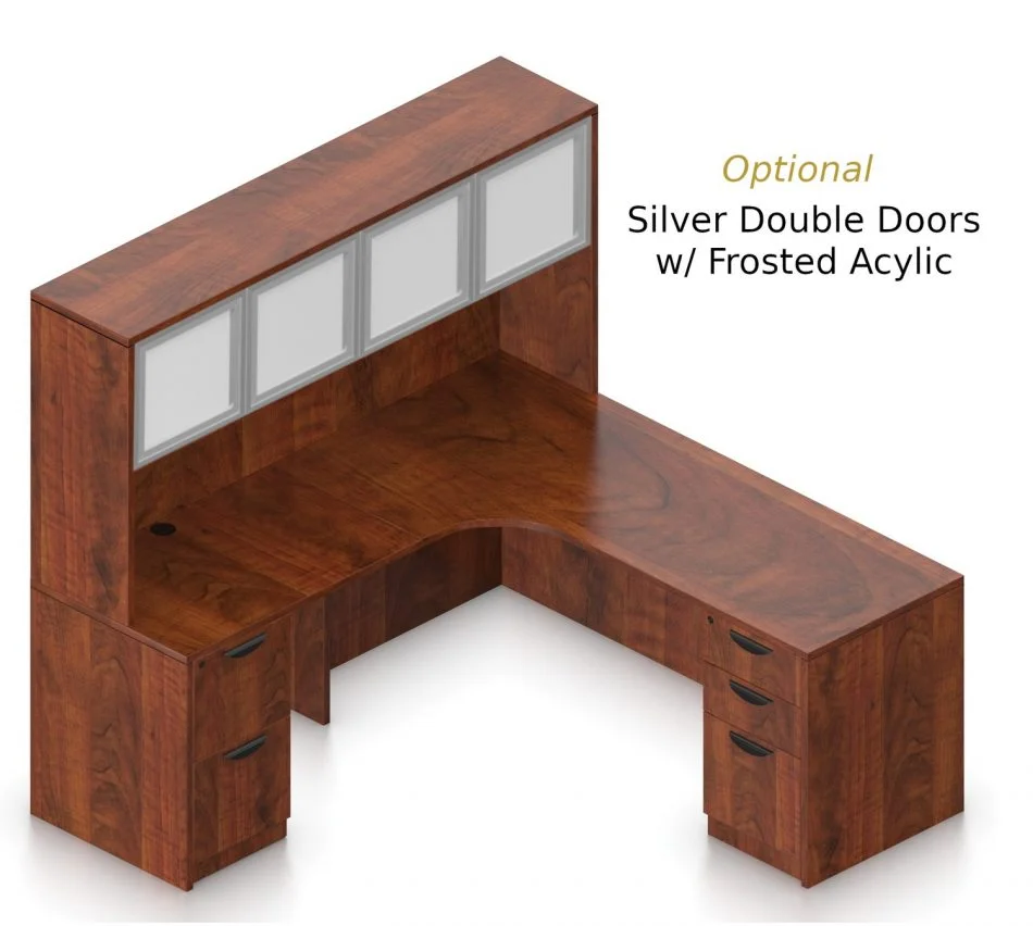 Orthographic view of an Offices to Go set of desking, using Layout L. This set consists of a 71" corner desk, with matching hutch stacked at the left corner extension. The hutch has two cabinets, shown with optional silver frame and frosted acrylic double doors. Within the desk, at each side, is a set of pedestal drawers. The extension side features two equal height drawers, and the other side features a set of three drawers. Each one has a lock at the top. This desking uses an American Dark Cherry laminate finish.