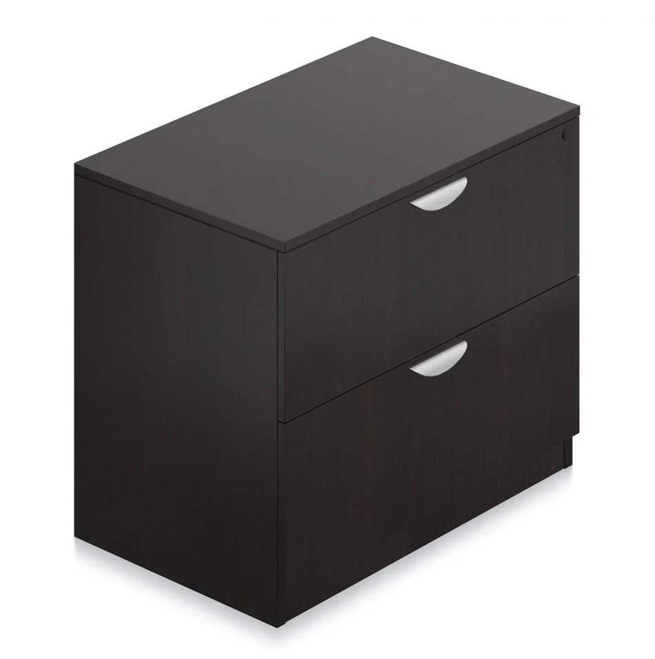 Orthographic view of an Offices to Go 2-drawer storage cabinet. The top drawer features a lock. This set uses an American Espresso laminate finish.