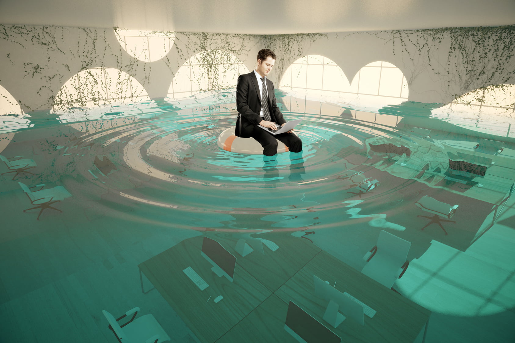 office worker on top of desk surrounded by water