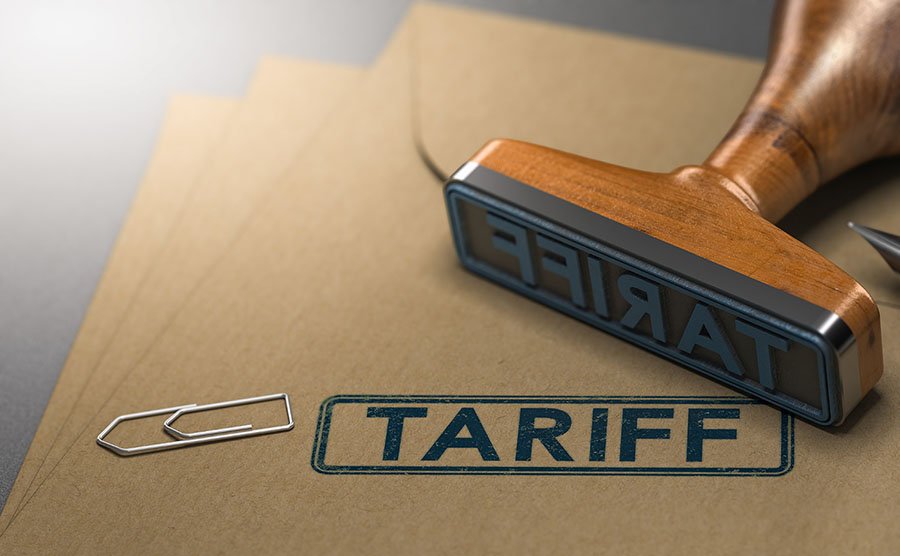stamp with words tariff on it lying on files with a paperclip