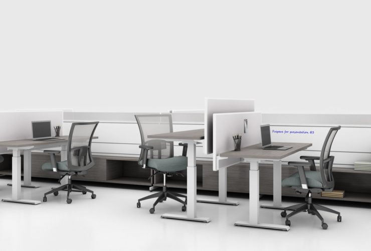 Global's 8-person power beam desks in a white studio setting. Each workstation has a laptop open. To the user's right are credenzas with Acoujou paneling