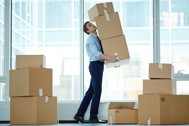 businessman carrying moving boxes