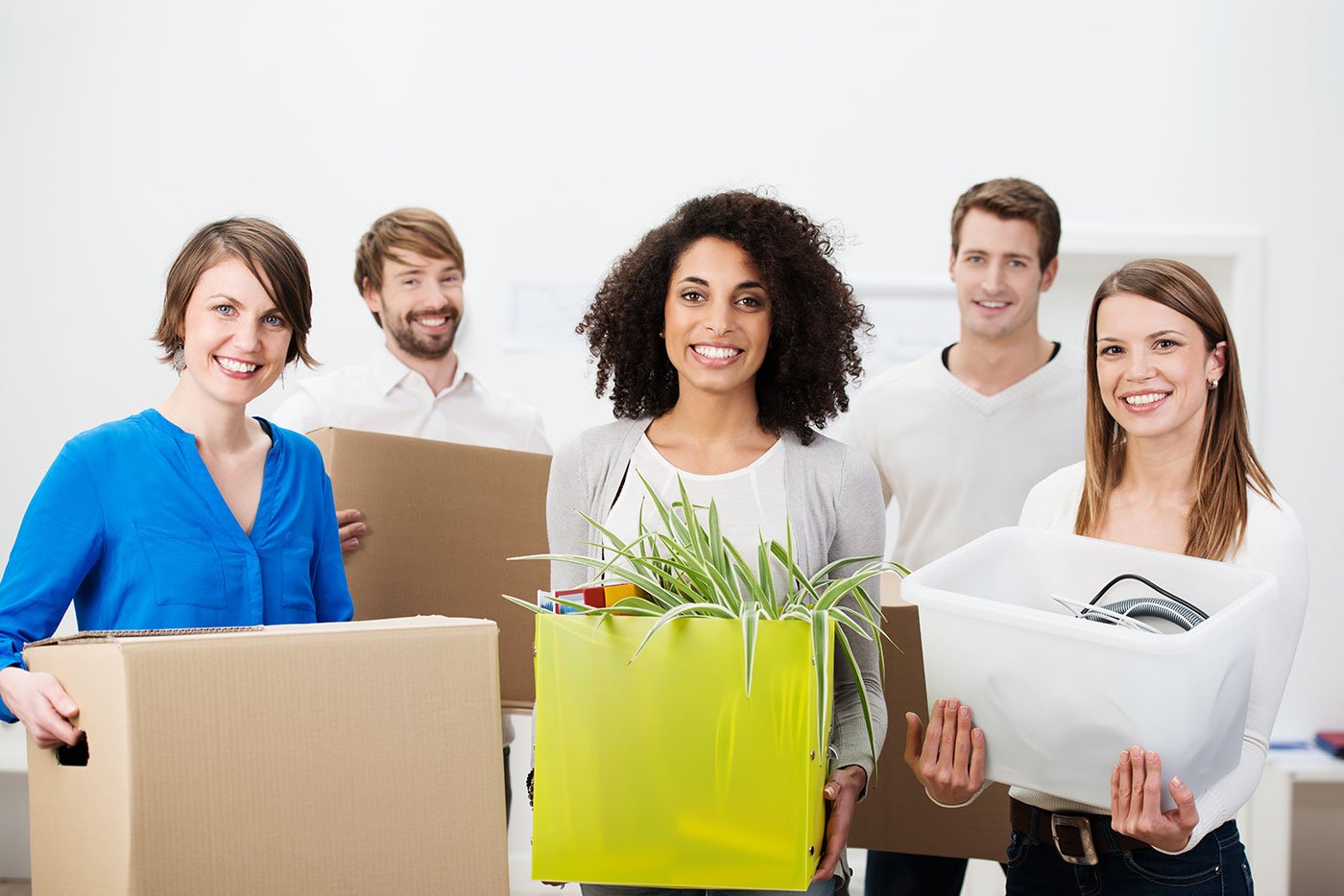 smiling employees with moving boxes because they used an office move day checklist