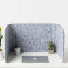 Hide privacy screen, using charcoal colored PET. A laptop is closed, with a few small plants in front of it.