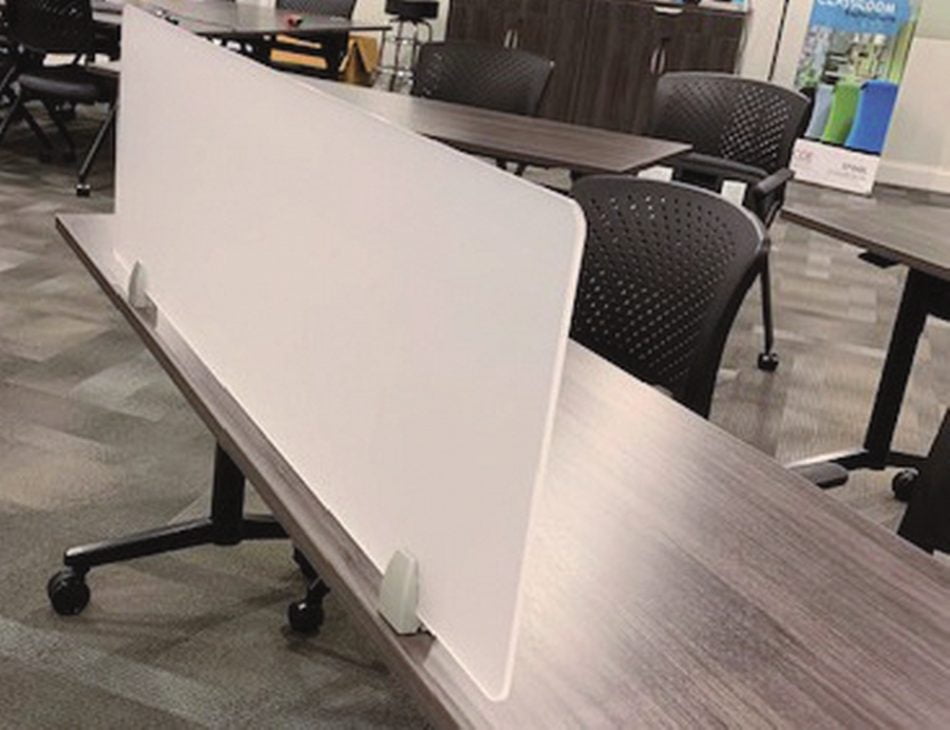 Work table with a Straight(model) space divider, using frosted acrylic. A low backed chair is seated at this table.