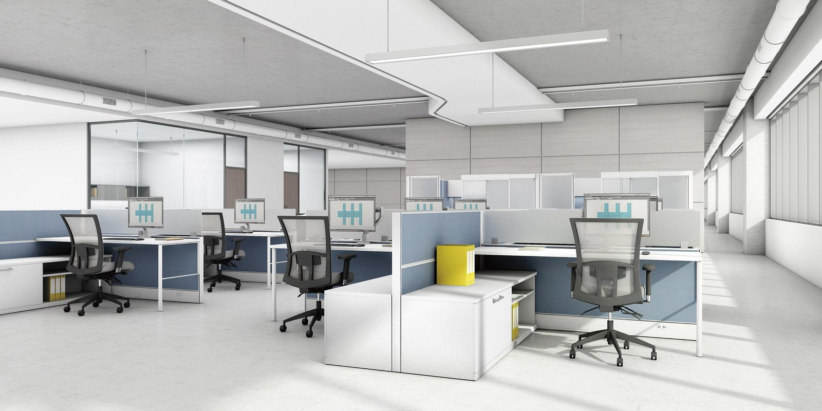 An array of Compile model workstations in an open office plan. Each workstation has a rollaway chair, computer and set of storage to one side.