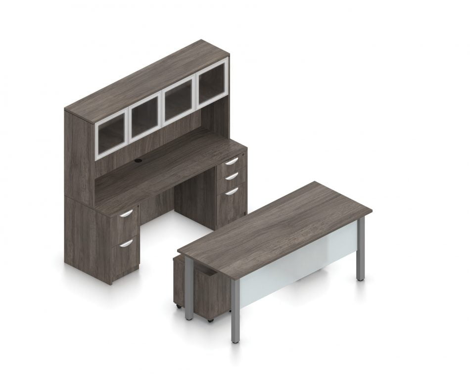 Orthographic view of an Offices to Go desk and table set, using Layout 2. This set consists of a 71" wide metal table and a matching width credenza behind. The hutch above features double silver doors with frosted glass, and provides shelving for storage. A pair of rolling pedestal file drawers are pushed under the table, with an acrylic privacy panel in front, mounted under the desk. This layout is shown with the Artisan Grey laminate finish.