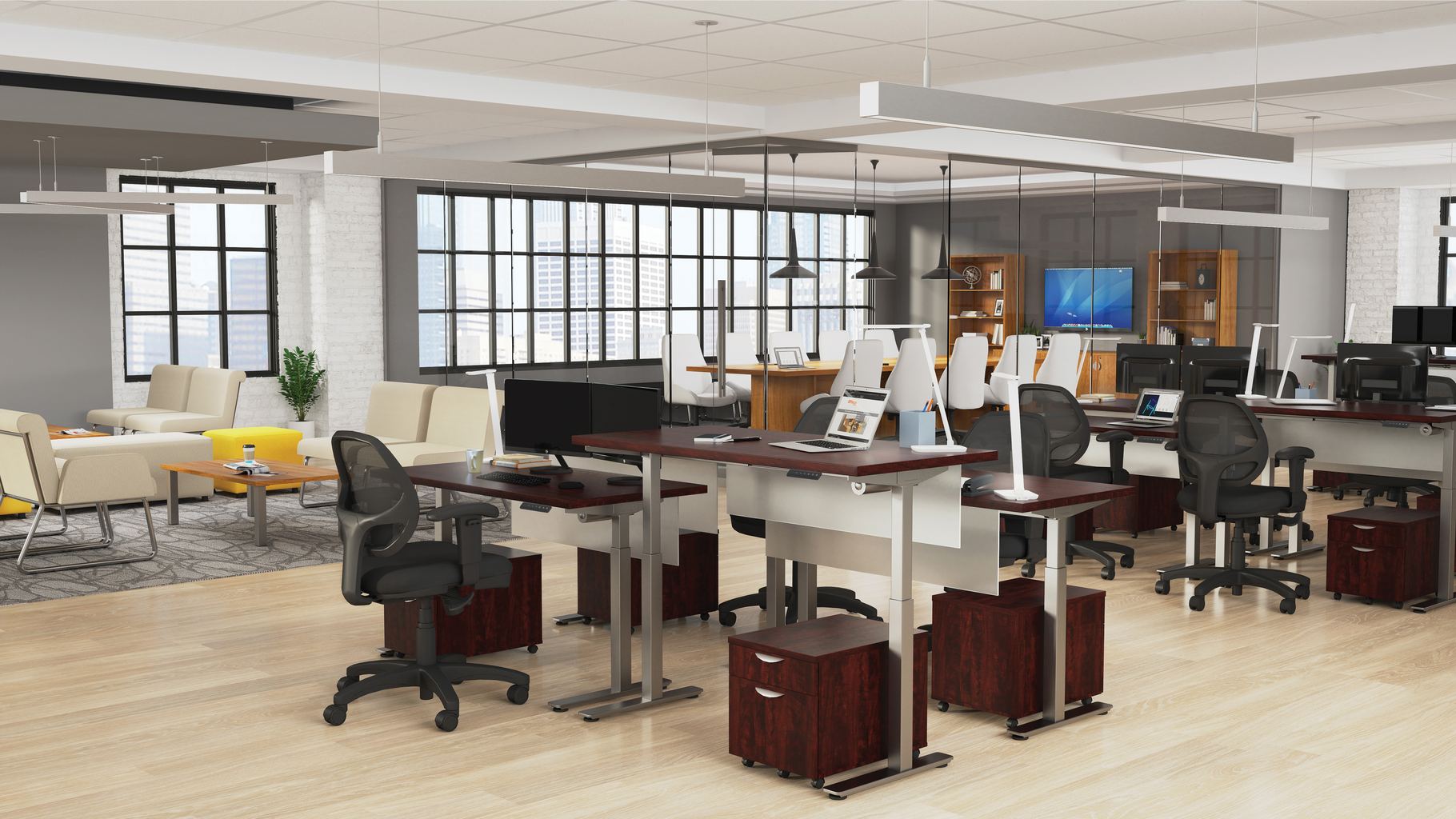 Studio photography of Offices to Go's laminate height adjustable workstations. Two groups of four stations are set together, each with an LED desk lamp and computer. A set of 2 drawers is wheeled in each space, with storage for supplies. A clear glass conference room can be seen in the background, by the open office's windows, with an additional casual seating area to the left.